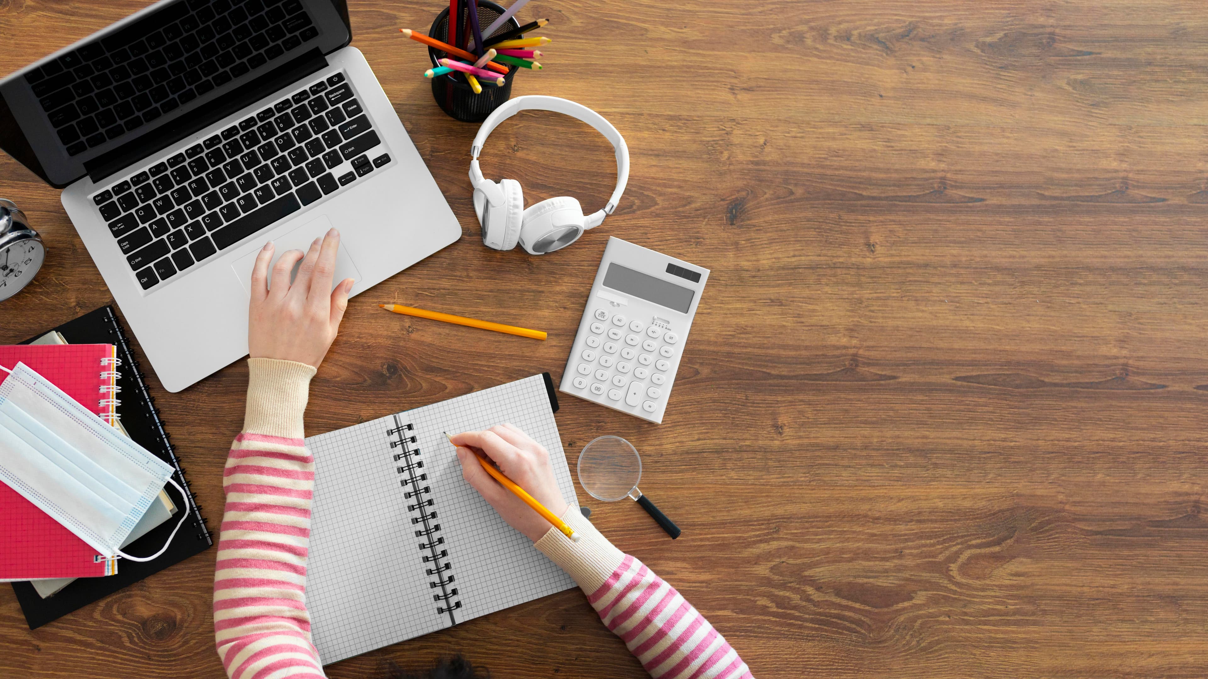 Pessoa fazendo anotações enquanto avalia alternativas de estudo